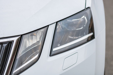 Close up photo of modern and clean car, detail of headlight. Headlight car Projector/LED of a...