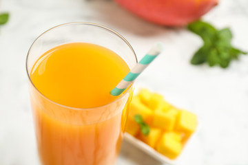 Fresh delicious mango drink on table, closeup