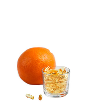 Jelly pills with vitamins, a remedy for cellulite, a means for weight loss. Orange in the background. Vertical photo on a white background with space for text on top.