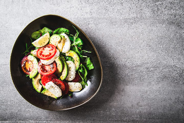 Healthy salad plate on concrete background top view. Healthy green raw food. Superfood vegetarian meal. Dieting	