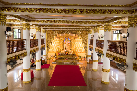 The pure white marble statue of Buddha outside of Myanmar temple in Singapore. Maha Sasana Ramsi Burmese Temple is a religious landmark in Singapore
