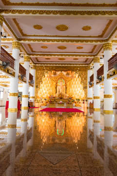 The pure white marble statue of Buddha outside of Myanmar temple in Singapore. Maha Sasana Ramsi Burmese Temple is a religious landmark in Singapore