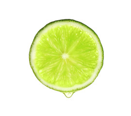 Slice of lime with dripping essential oil isolated on white