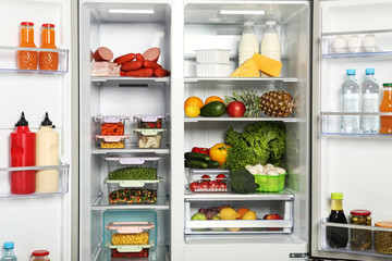 Open refrigerator full of different fresh products