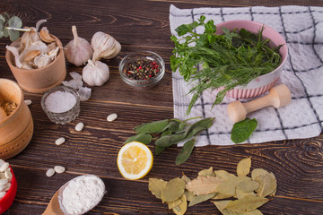 Spices and fresh herbs on wooden table. Set of organic healthy food.
