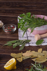 Fresh herbs and spices on wooden table. Different fresh ingredients for cooking food. Healthy eating conept.