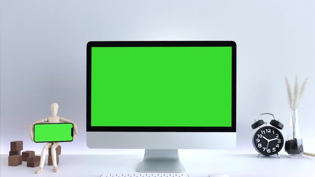 Computer desktop with mock-up green screen white background  in office, Zoom shoulder view.