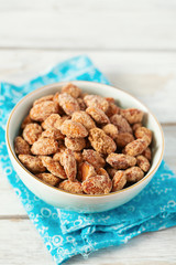 caramelized almonds on white wooden surface