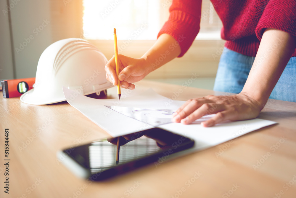 Wall mural Engineer is drawing on his desk