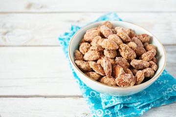 caramelized almonds on white wooden surface