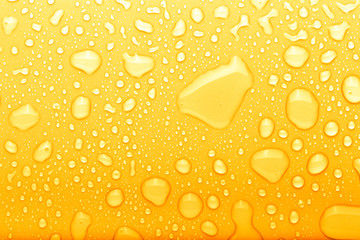 Drops of water on a color background. Selective focus. Yellow. Toned