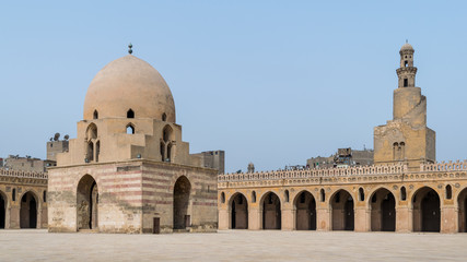 Fototapeta na wymiar Courtyard of Ibn Tulun public historical mosque with ablution fountain and the minaret, Sayyida Zaynab district, Medieval Cairo, Egypt