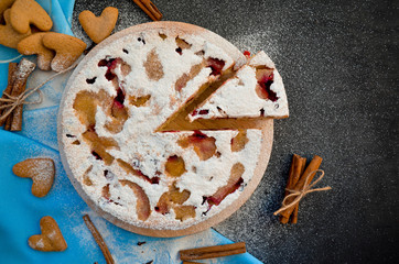 Apple pie on a black background, top view