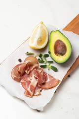 avocado, jerky and lemon closeup on a white background