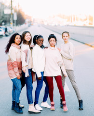 Fototapeta premium Multiracial group of friends stands on city street.