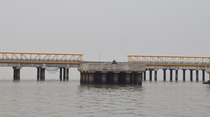 Fototapeta na wymiar Mumbai, Maharastra/India- January 13 2019: Bridges connecting a floating platform located near the sea port.
