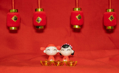 The Chinese New Year decoration on a red background Chinese Couple Figure Model wish for a Luck  and lump of gold and a Chinese Word on Lantern  said Luck