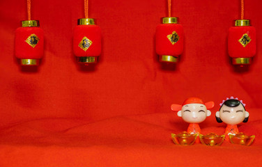 The Chinese New Year decoration on a red background Chinese Couple Figure Model wish for a Luck  and lump of gold and a Chinese Word on Lantern  said Luck