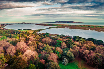 Aerial view over St. Anne Park in autumn revealing North Bull Island and the Howth peninsula on the...