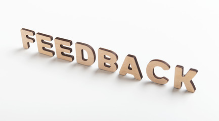 Word feedback of wooden letters on white background