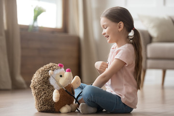 Cute little girl playing doctor with toy and stethoscope