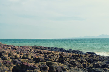 stone beach and sea with blue sky nature wallpaper background