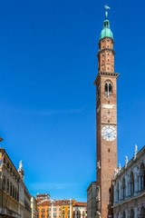 Obraz premium Vicenza, Italy. View of clock tower (Torre Bissara) at famous square (Piazza dei Signori) in Vicenza.