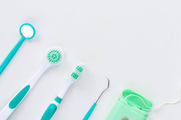 Toothbrushes and hygiene products on a white background. Top view.