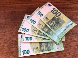 euro banknotes on wooden table close-up. EU currency. Copy space