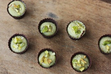 Delicious chocolate candies with pistachios on the table