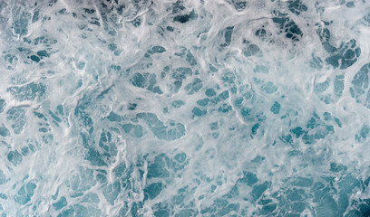 Sea foam moving in the ocean