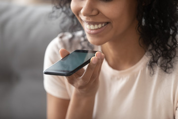 Woman speaking using loudspeaker on smartphone closeup focus on device