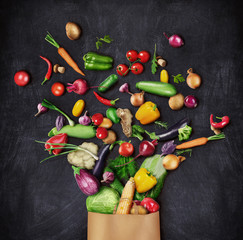 Healthy food is poured from a paper bag on a dark background. Healthy eating concept.