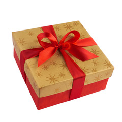 Red gift or present box with golden colored top and red ribbon bow isolated on white background closeup