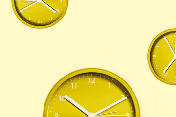 Creative background with yellow clocks.
