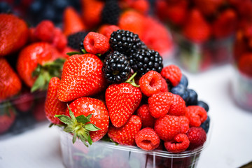 fresh berries close up - strawberries, blueberries, red berries, raspberry, black berries 