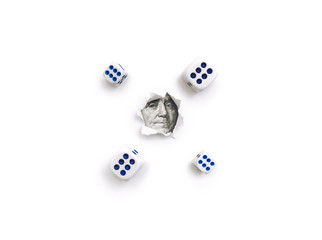 Franklin portrait in a torn hole of white paper and dice. The concept of gambling, casino, losing and luck. Win or lose. Copy space.