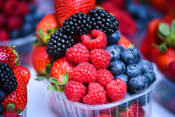 fresh berries close up - strawberries, blueberries, red berries, raspberry, black berries 
