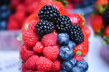 fresh berries close up - strawberries, blueberries, red berries, raspberry, black berries 