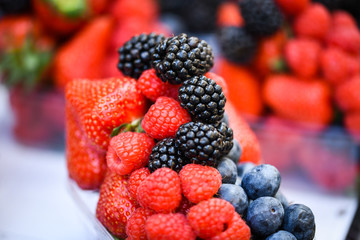 fresh berries close up - strawberries, blueberries, red berries, raspberry, black berries 