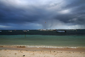 fishing and tourist boats near the shore at sunset on a tropical island