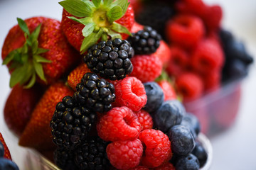 fresh berries close up - strawberries, blueberries, red berries, raspberry, black berries 