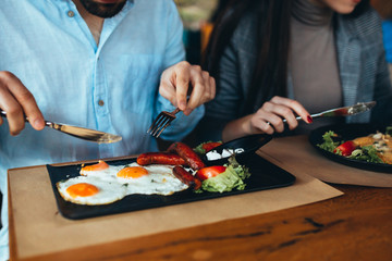 close up people eating food in restaurant