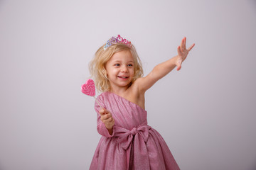 beautiful little blonde girl with a heart shaped Lollipop