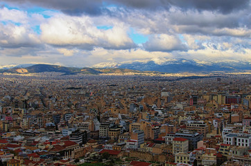 Aerial view over the city of Athens against cloudy sky. Famous touristic place and travel destination in Europe. Greece