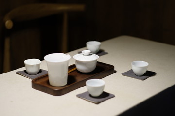 Obraz na płótnie Canvas close up a tea set on the white table. blur dark background