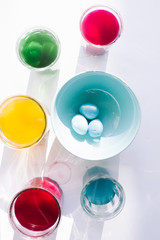 Coloring hard-boiled eggs easter tradition, naturally dyed eggs for easter holiday using natural ingredients, top view flat lay composition