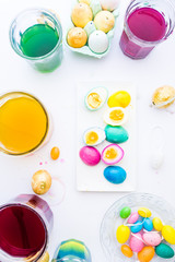 Coloring hard-boiled eggs easter tradition, naturally dyed eggs for easter holiday using natural ingredients, top view flat lay composition
