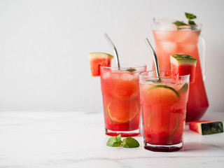 Watermelon cooler with lime, mint and ice. Perfect homemade watermelon drink in glasses with metal...