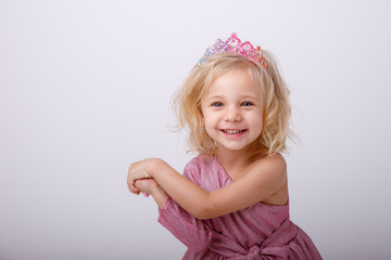 beautiful little blonde girl with a heart shaped Lollipop